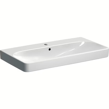 Biała umywalka wisząca Geberit Smyle Square 90x48 cm z ceramiki sanitarnej z przelewem i otworem na baterię pro.