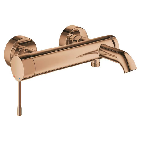 Ścienna bateria wannowa Grohe Essence New w wykończeniu warm sunset z przełącznikiem wanna/prysznic