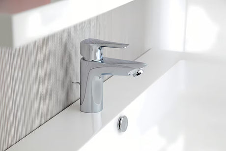 Chromowana jednouchwytowa stojąca bateria umywalkowa Hansgrohe HG248 z odpływem o zaokrąglonym designie