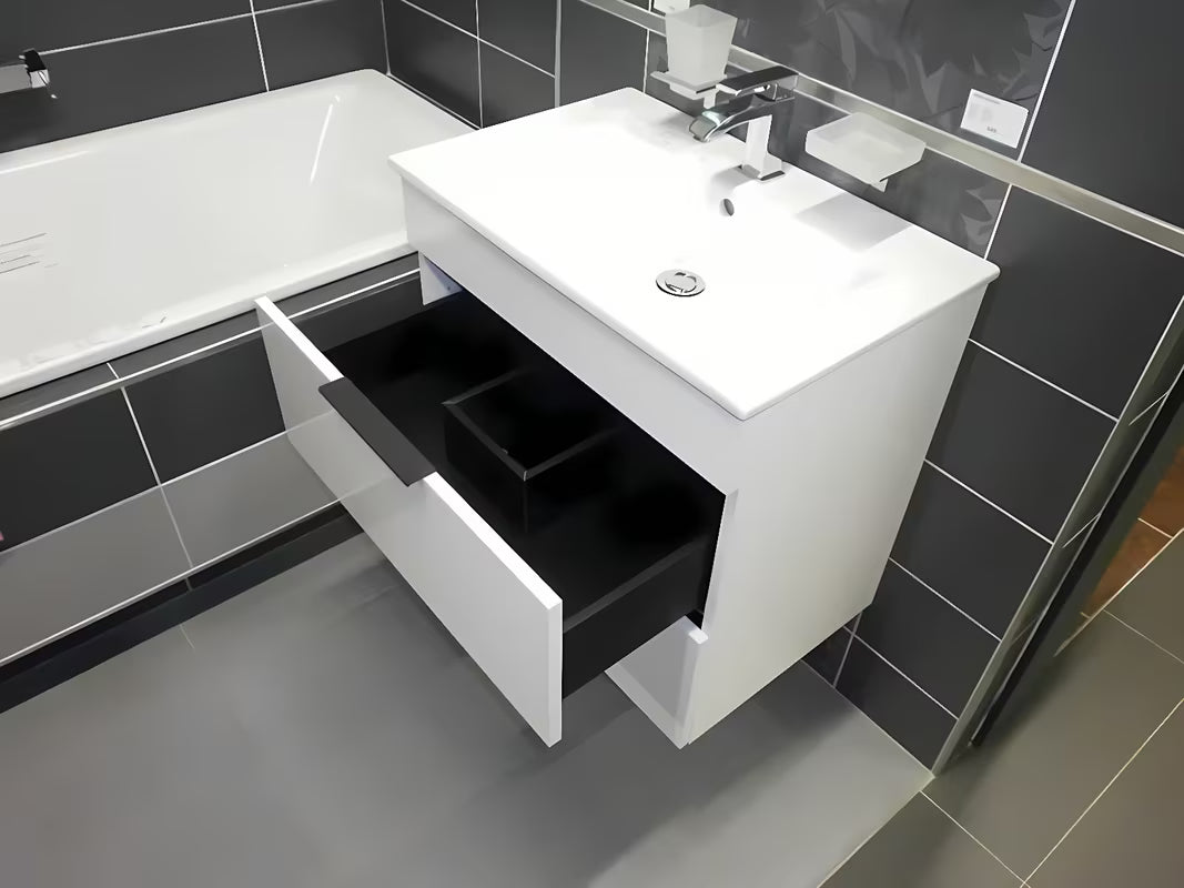 Biała szafka wisząca Jika Plan z umywalką ceramiczną i szufladami z pełnym wysuwem.