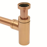 Mosiężny syfon umywalkowy SAT Aurum w kolorze rose gold, o okrągłym kształcie i średnicy 32 mm.
