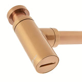 Mosiężny syfon umywalkowy SAT Aurum w kolorze rose gold, o okrągłym kształcie i średnicy 32 mm.